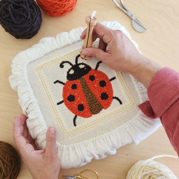 Two hands punching a red and black ladybug pattern